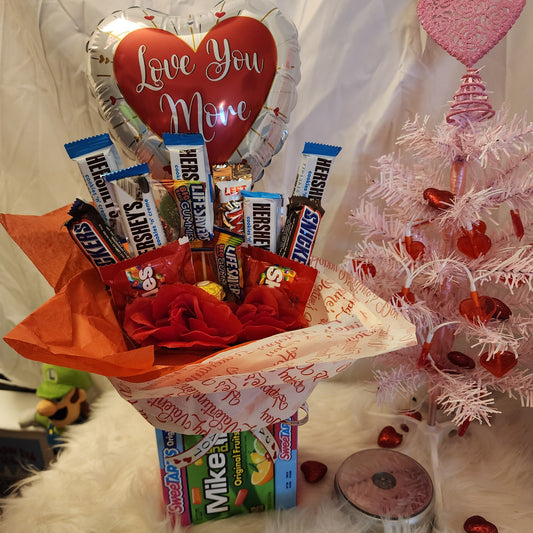 Bouquet of candy and balloons on a white surface