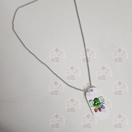 A white aluminum military tag pendant with 'Best Dad Ever' text and graphics, attached to a silver chain.