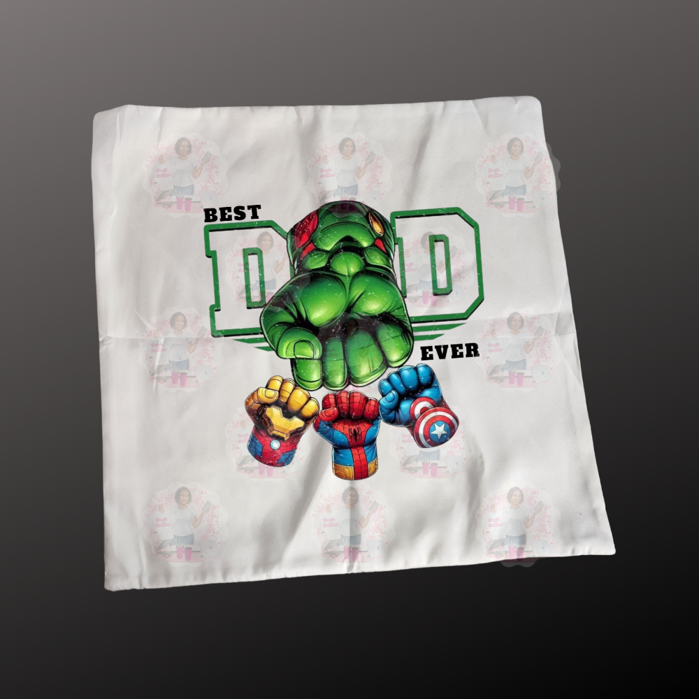A decorative pillow case with a graphic design of a superhero character and the text 'BEST DAD EVER'.