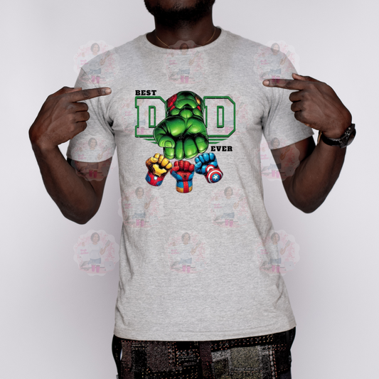A person wearing a gray t-shirt with a graphic design of a superhero character and the text 'BEST DAD EVER'.
